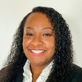 A woman with dark hair, wearing black blazer