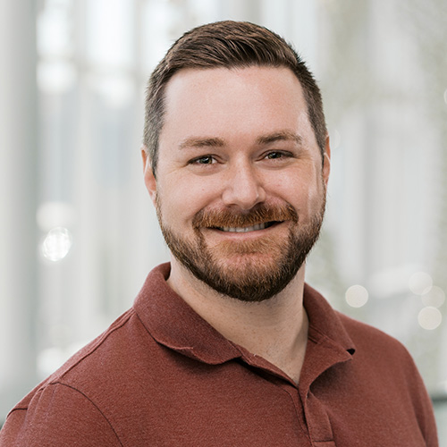 Bearded man in maroon polo shirt