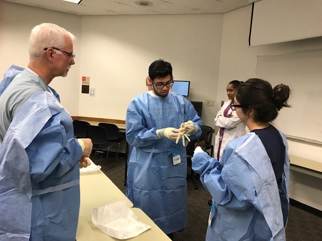 Medical students gloving