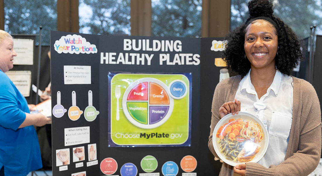 Anita Harry poses for camera the building healthy plates display