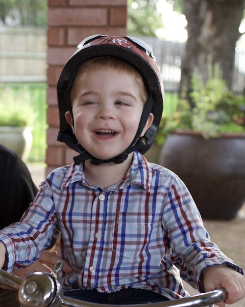Joseph Hann rides his tricycle at his family’s home in the Dallas area, a task he is no longer able to enjoy due to his deteriorating nervous system.
