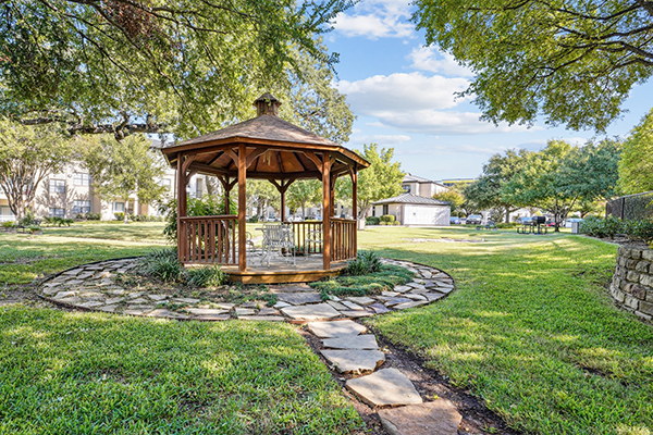 Grassy area with stepping stones and gazebo