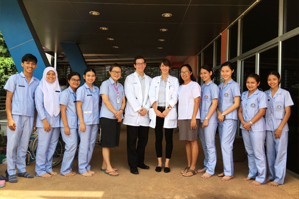 Taylore King and a group of nurses in front of a hospital in Surat Thani