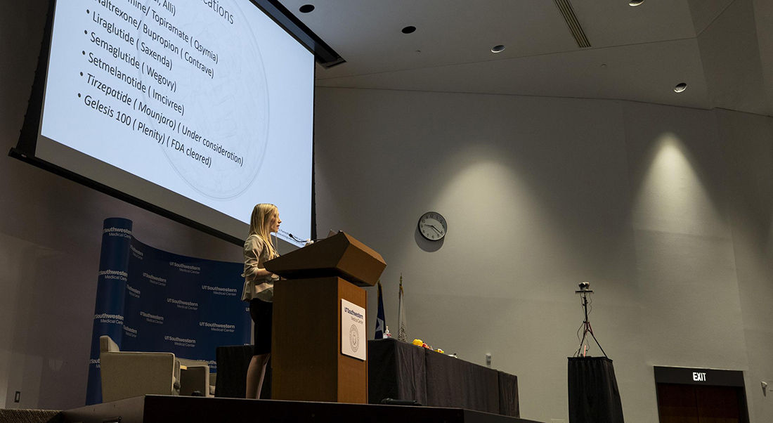 Dr. Gazda at podium on stage during a presentation