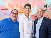 Dr. de la Cruz poses for a photo with members of the Dallas Resource Center.