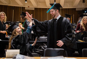 Dr. Shannon McReynolds and Dr. Kevin McGehee, who earned their doctor of physical therapy degrees, celebrate their achievements with a high-five.
