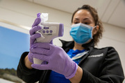 Dora Irma Garcia sanitizes a thermometer in between screenings.