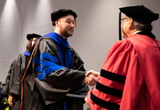 Dr. Nicholas Holder receives a presidential handshake.