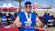 David Nelson on UTSW's Human Resources Talent Development team shows off his medal, which indicates that he's a heart disease survivor.