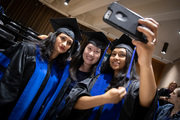 Drs. Bishakha Mona, Yi-Li Min, and Hema Manjunath snap a selfie before commencement.