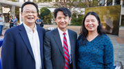 Three attendees enjoy the once-in-a-lifetime event together.