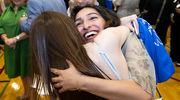 Anjali Kalra (smiling) gives her friend a big hug after learning of her match.