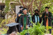 Dr. Zachary Christian (forefront) graduated with Distinction in Research and Dr. Alvin Chung (background)