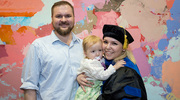 Natalie Ortiz Speer, Ph.D., enjoys the once-in-a-lifetime milestone with her husband and daughter.