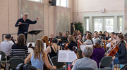 Conductor Willich directs the orchestra on another composition.