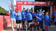 A group gets together to celebrate at the finish line.