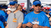 Executive leadership hand out UTSW swag. Pictured from left are Chris Rubio, M.B.A., Vice President and Chief Operating Officer, Health System, and Marc Nivet, Ed.D., M.B.A., Executive Vice President for Institutional Advancement.