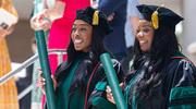 Erica Ogwumike, M.D. (left), and Olivia Iheme, M.D., are all smiles after receiving their degrees.