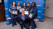 David Nelson, Senior Program Coordinator for Talent Development, poses with the Platinum pin recipients.