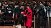 Dr. Podolsky bestows a diploma to a graduate during the ceremony.