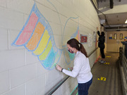 Medical student Kendra Maple gives these angel wings the rainbow treatment.