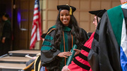 Pure joy lights up the face of graduate Limi Jamma, M.D., as she receives her diploma