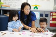 Ms. Moya works with two students on a STEM project.