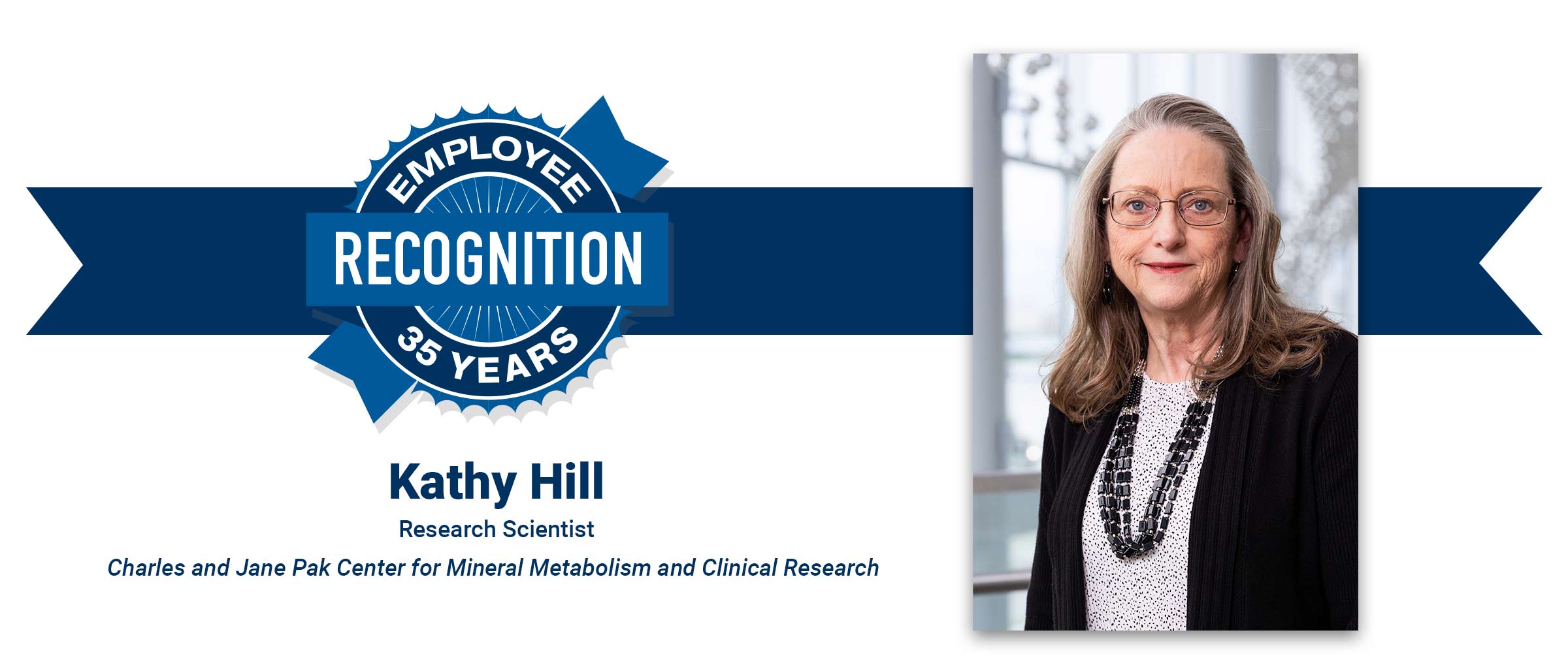 Woman with long hair, glasses, black shirt. Kathy Hill, 35 years employee recognition.