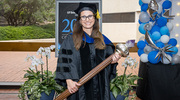 Maralice Conacci-Sorrell, Ph.D., Associate Professor of Cell Biology and in the Children’s Medical Center Research Institute at UT Southwestern, holds the Stembridge Mace she carried during the academic procession. The symbol represents the torch of learning and passing of knowledge from teacher to student over generations.
