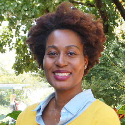 Woman with smiling and wearing yellow sweater