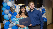 Natalia Rodriguez-Sosa, Ph.D., celebrates graduation beside her partner.