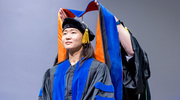 Da Hee Seo, Ph.D., stands ready to receive her hood at commencement.