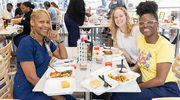 From left: Elekevu Sanders of Orthopaedic Surgery, Breanna Evans in Ambulatory Services, and Deshawn Maydwell of Orthopaedic Surgery enjoy their lunch break during the festivities.