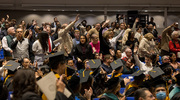 Family and friends cheer on the graduates.