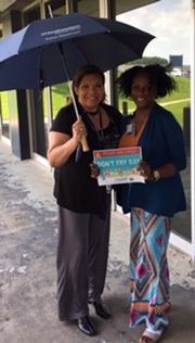 Susana Mendoza, Sr. Administrative Assistant, University Police (pictured with Nechelle Harris, Manager, University Police): We take cover under the shade of an umbrella!