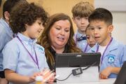 Mary Jones, a Sim Center educator, shows off technology used during a simulation.