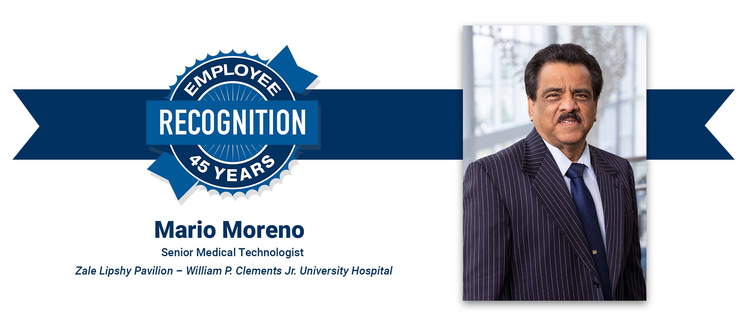Man with black hair, mustache, striped suite. Mario Moreno, 45 years employee recognition.