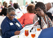 Some attendees took turns finding the names of honorees in the special edition of Center Times.