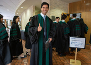 Thumbs up as students file in for the Hooding Ceremony.