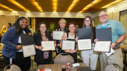 In the Corporate Collaboration (Amateur Division) category, members of an art team show off their first place certificates for an entry called Blossoming With Individuality. From left: Ciera Starkey, Julia Wilkerson, Dr. Stacy Pritt, Brittney Hubbard, Kathryn Cavanaugh, and Vince Snoddy. Not pictured are Lenesha Horner, Melissa Torres-Altoro, Beth Trumpower, Courtney Mitchell, Sandy Parker, and Nicholaus Krieter.