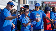 Jonathan Efron, M.D., Executive Vice President for Health System Affairs, hands out swag at his first Dallas Heart Walk with UT Southwestern. He’s pictured with his wife, Jami Terry, and UTSW cardiologist Sandeep Das, M.D., M.P.H.