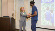 Holly Crawford, Executive Vice President for Business Affairs, presents Dwayne Bio his award in the digital art category for Love is Free; Freedom is Not. Mr. Bio earned first place in the Amateur Division category, won the People's Choice award, and also tied for Best in Show.