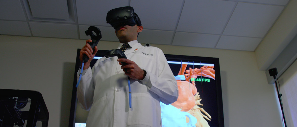 Man in lab coat using a VR headset and controllers