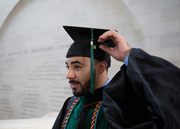 Dr. Evan Wright adjusts his tassel before the ceremony.