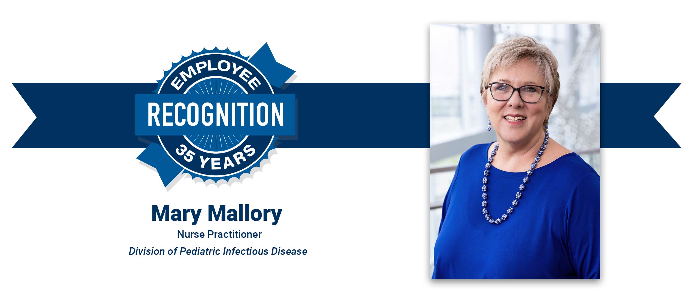 Woman with white hair, glasses, wearing beaded necklace and blue top. Mary Mallory, 35 years employee recognition