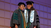 Dr. Mihalic (right) provides encouraging words as Rasika Reddy, M.D., prepares to walk across the stage.