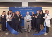 Former patients John Pomara and Frank Santoro (center) lead the ribbon cutting of the new West Campus Building 3.