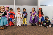 Batman takes a break as other trick-or-treaters line up with their Halloween candy hauls.