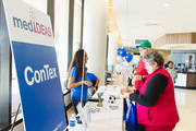 Dr. Nyaz Didehbani, UTSW Assistant Professor of Psychiatry, speaks with attendees at an information booth featuring the Texas Sports Concussion Registry, known as ConTex.