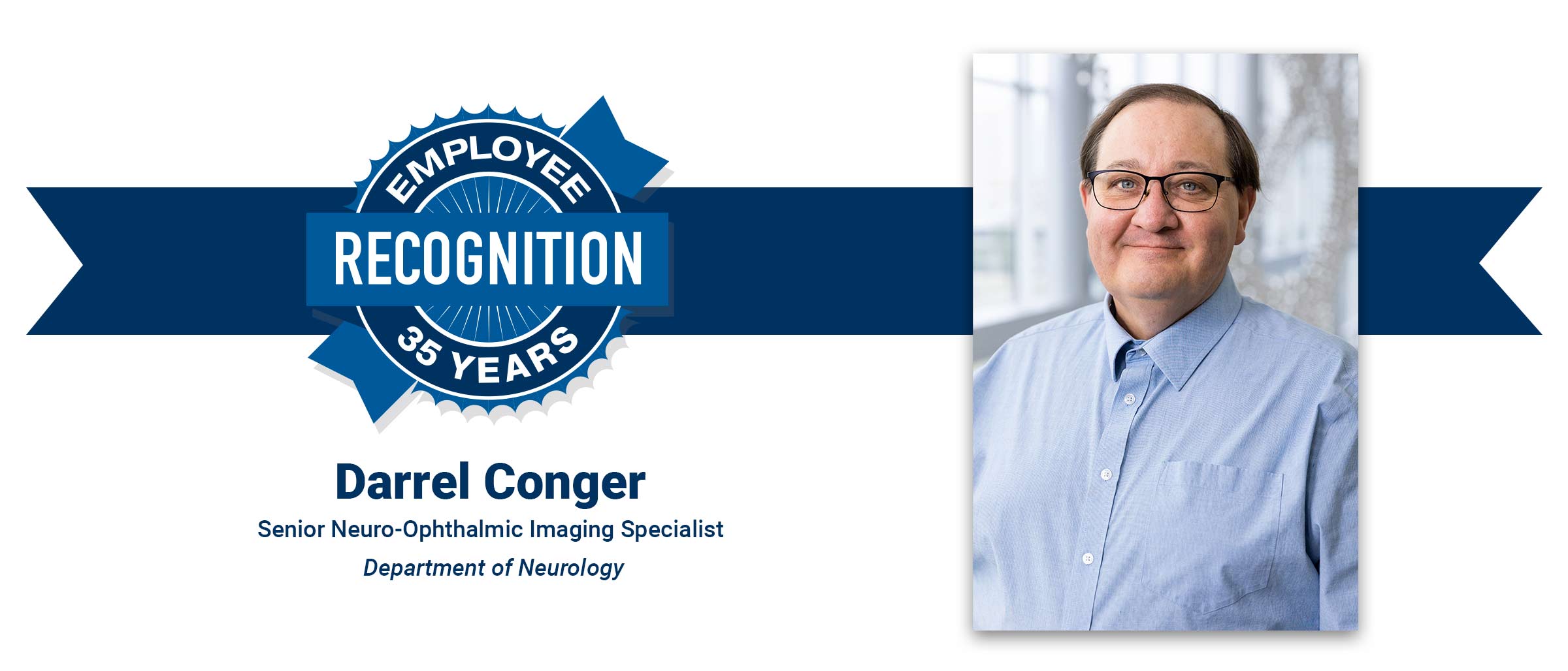 Man with brown hair, thin black glasses, blue collared button shirt. Darrel Conger, 35 years employee recognition.